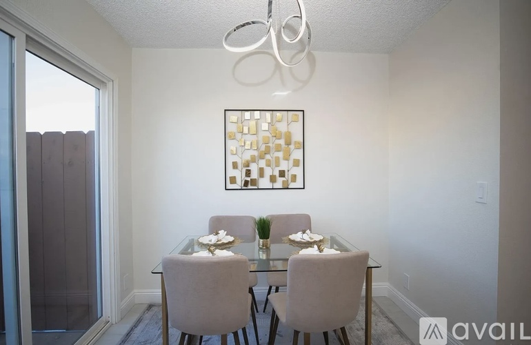 A dining room with a glass table and chairs.