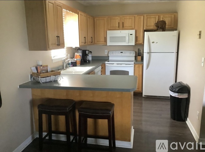 A kitchen with a white refrigerator and white oven.
