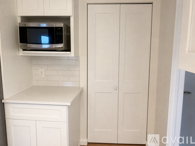 A kitchen with a microwave oven above a counter.