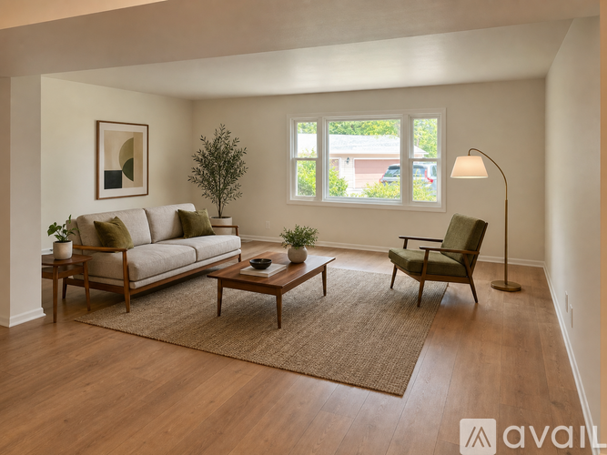 A living room with a couch, chair, and table.