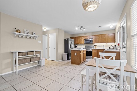 A kitchen with a white table and chairs.