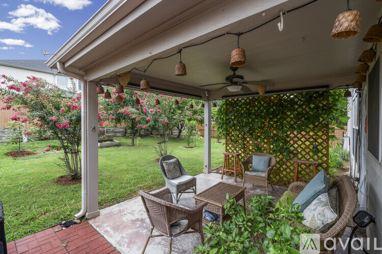 A patio with a table and chairs under a canopy.