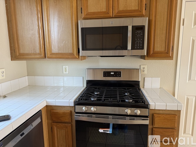 A kitchen with a stove and a microwave.