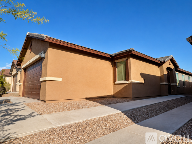 A house with a brown exterior and a garage door.