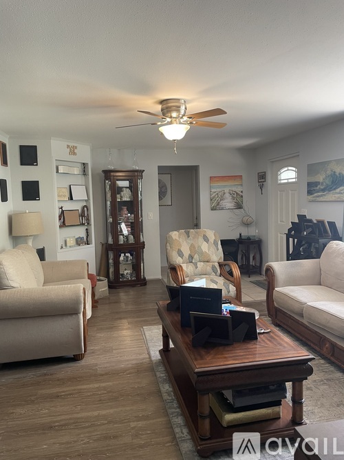 A living room with a wooden coffee table and two couches.