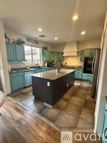 A kitchen with a black island in the middle of it.