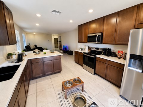 A kitchen with brown cabinets and stainless steel appliances.