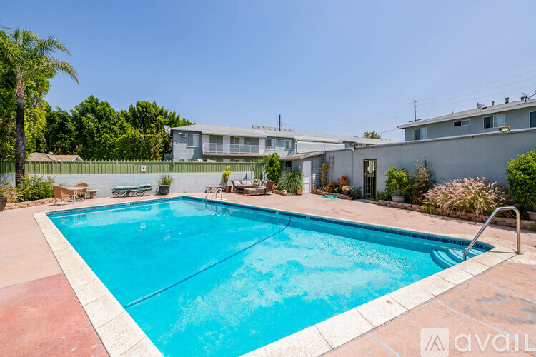 A pool with a red border and a silver ladder.