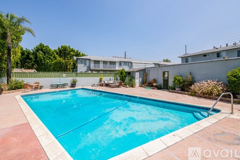 A pool with a red border and a silver ladder.