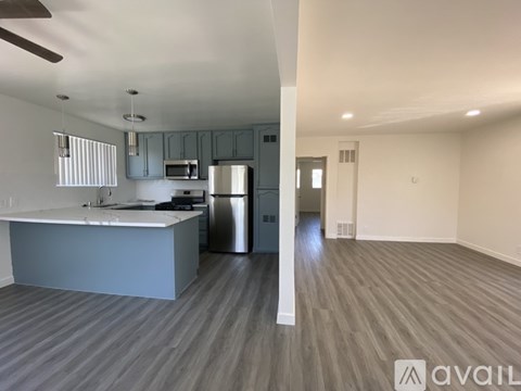 A kitchen with a counter and a fridge.