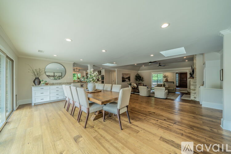 A dining room with a long table and chairs.