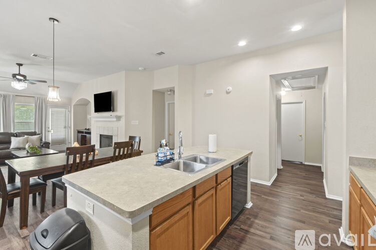 A kitchen with a dining table and chairs.