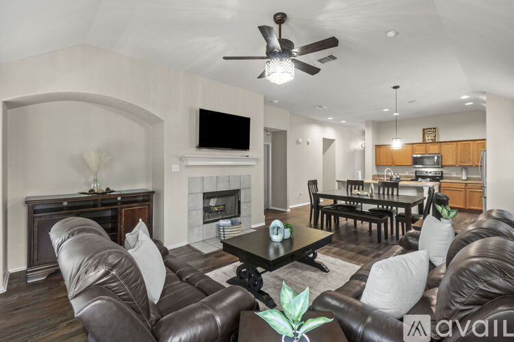 A living room with a fireplace and a television.