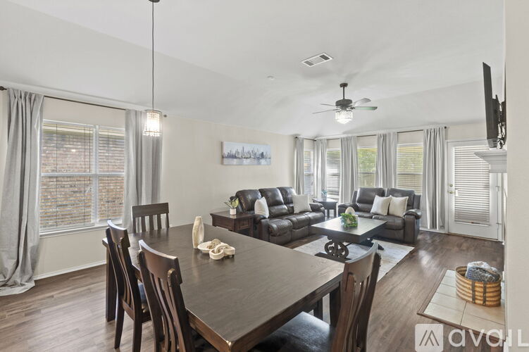 A modern dining room with a wooden table and chairs.