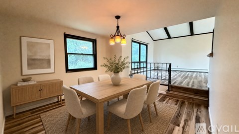 A dining room with a wooden table and chairs.