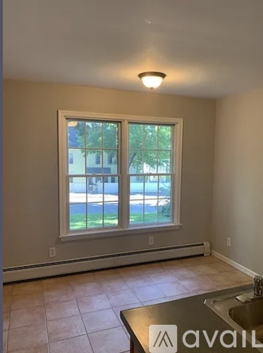 A kitchen with a window overlooking a street.