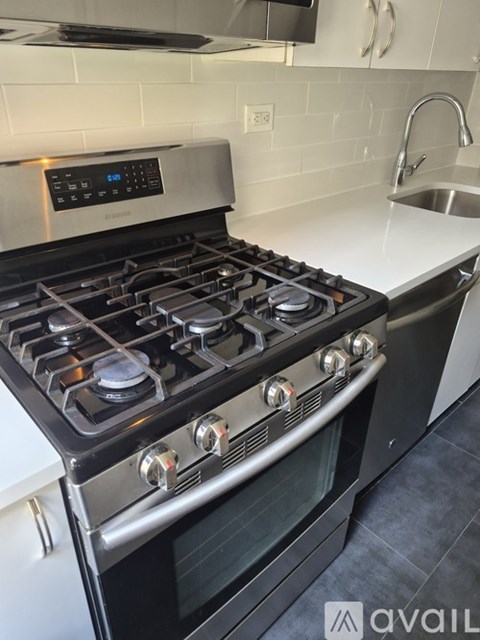 A modern black gas stove with a digital control panel.