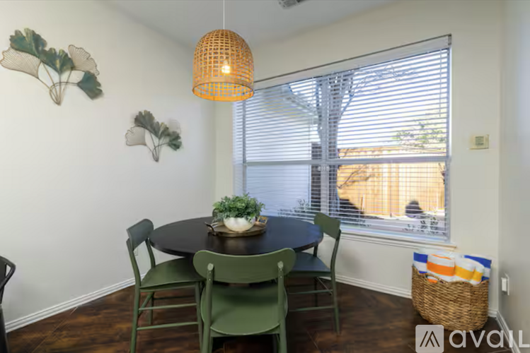 A dining room with a table and chairs.