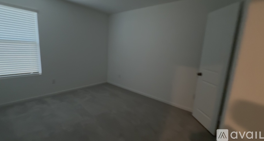 A room with a window and a door.