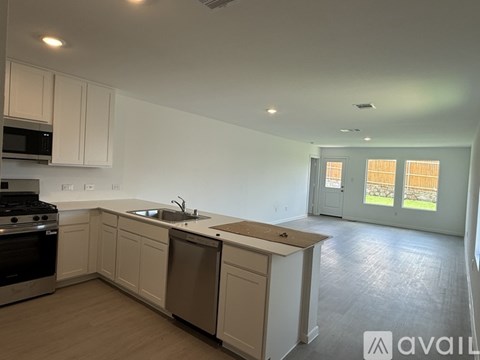 A kitchen with white cabinets and a sink.