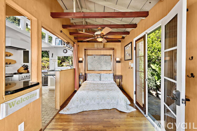 A bedroom with a bed in the middle of the room.