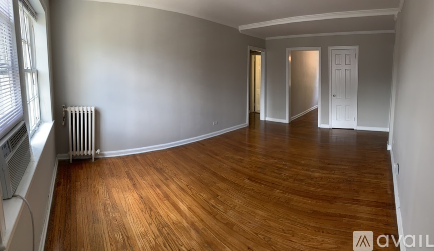 A room with wooden floors and white walls.