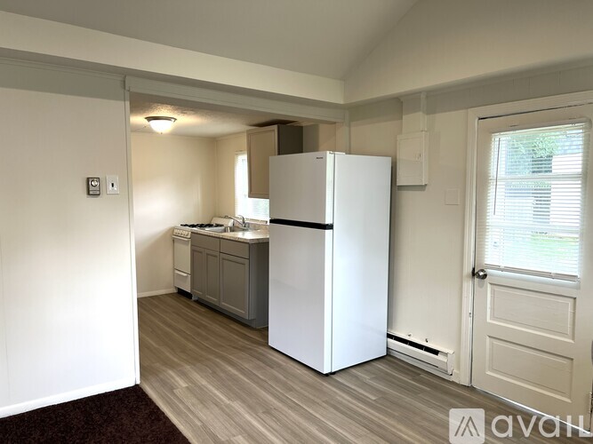 A kitchen with a white fridge, dishwasher and oven.