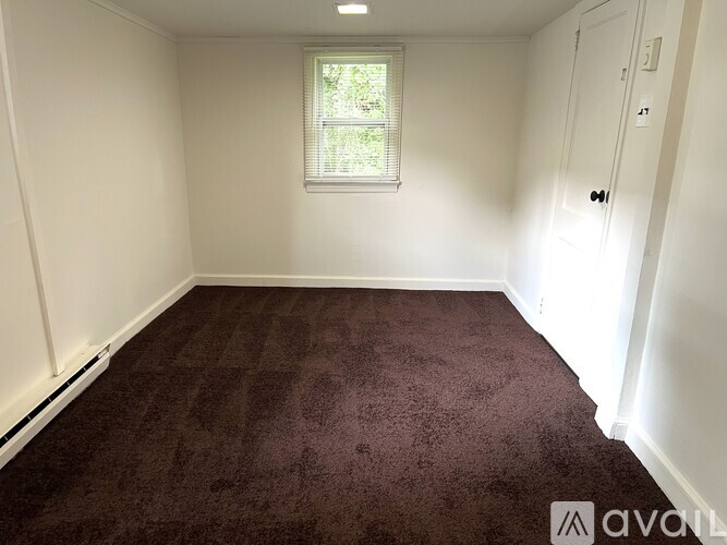 A room with a window and a door.