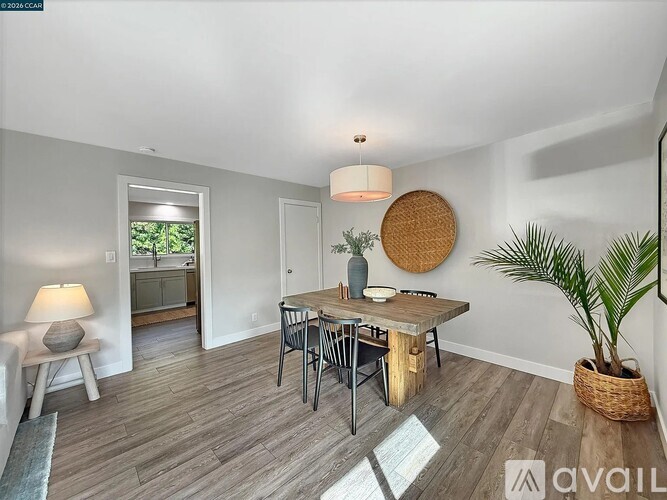 A dining room with a wooden table and chairs.