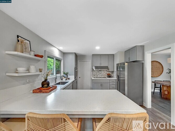 A modern kitchen with a dining table and chairs.