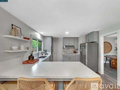 A modern kitchen with a dining table and chairs.