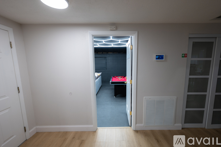 A room with a doorway leading to a bedroom.