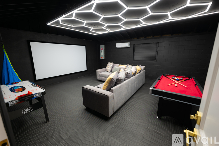 A room with a pool table and a couch.