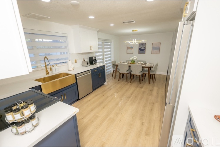 A kitchen with blue cabinets and a white countertop.