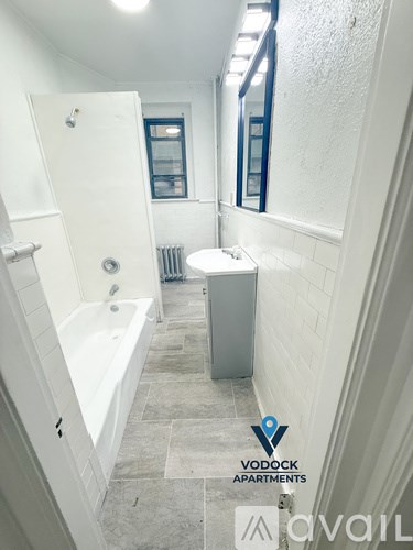 A bathroom with a white bathtub and a toilet in it.