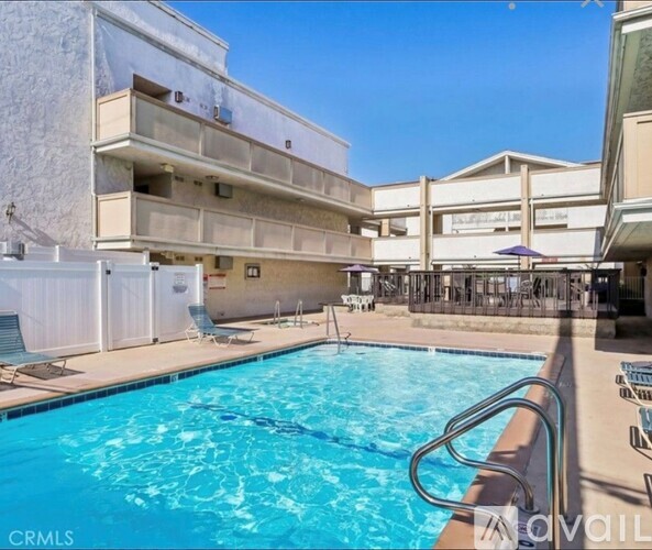 A pool area with a clear blue sky in the background.