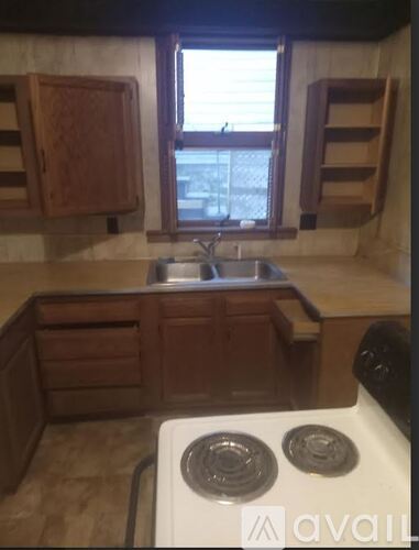 A kitchen with a stove top oven and a sink.