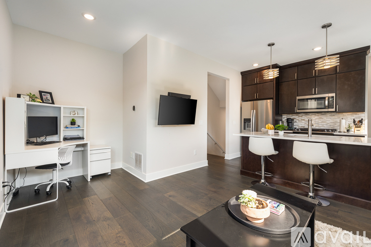 A modern kitchen with a dining table and chairs.