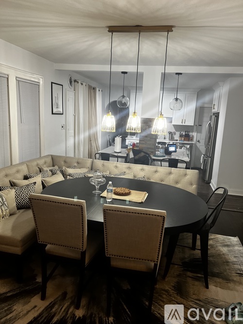 A modern dining area with a round table and chairs.
