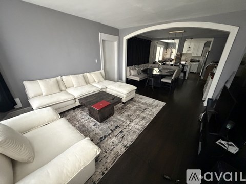 A living room with a white couch and a coffee table.