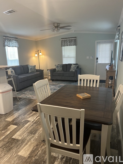 A dining room with a wooden table and chairs.