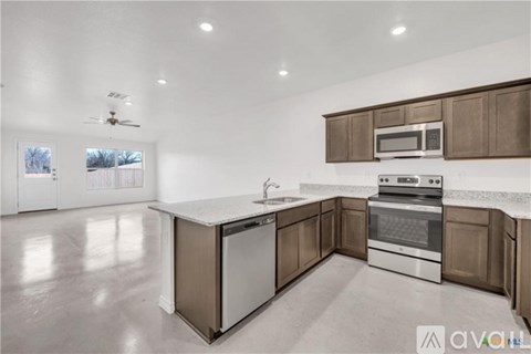 A modern kitchen with a stainless steel oven and microwave.
