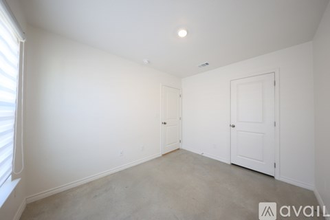 A room with white walls and a door is available for rent.