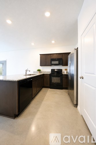 A kitchen with a granite countertop and a microwave above it.