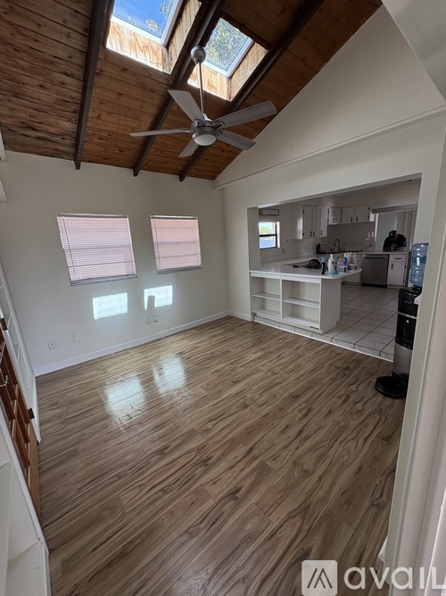 A room with wooden floors and a ceiling fan.