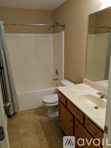 A bathroom with a toilet, sink, and shower.