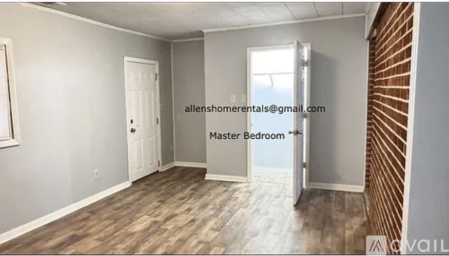 A room with a wooden floor and a white door is labeled as the master bedroom.