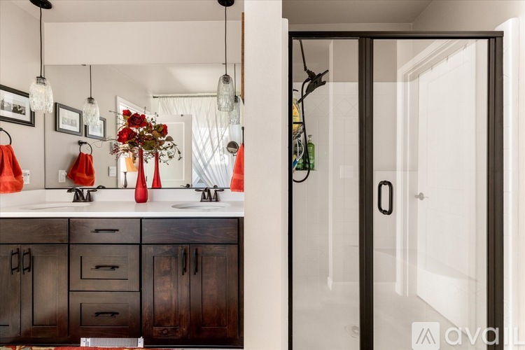 A modern kitchen with dark wood cabinets and a white countertop.