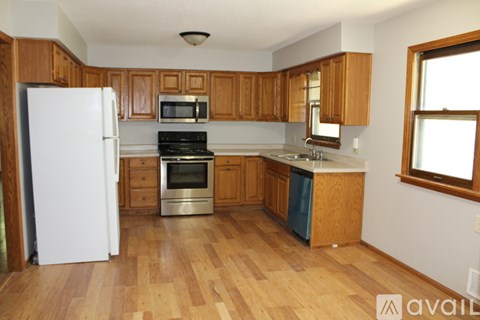 A kitchen with wooden cabinets and a white refrigerator.