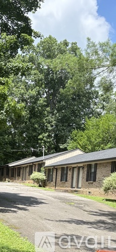A row of houses with trees in the background.